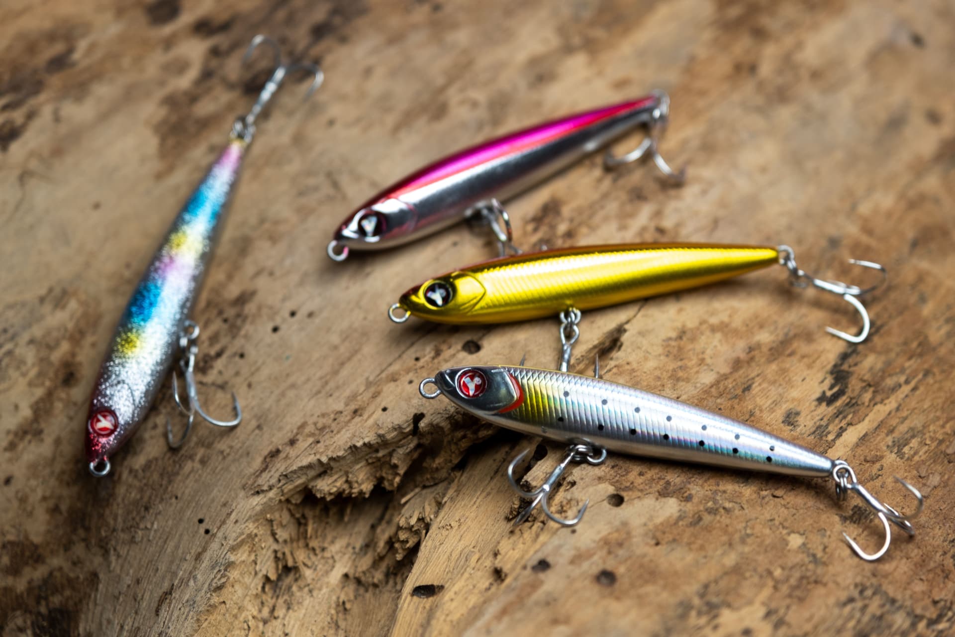 Magdalena Bay Lure Kit with four colorful fishing lures on a textured wooden surface for sportfishing.